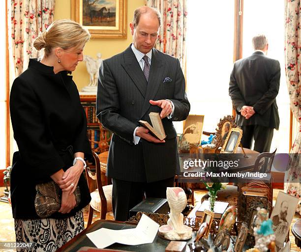 Sophie, Countess of Wessex and Prince Edward, Earl of Wessex view Queen Victoria's and Prince Albert's writing desk as they tour Osborne House during...