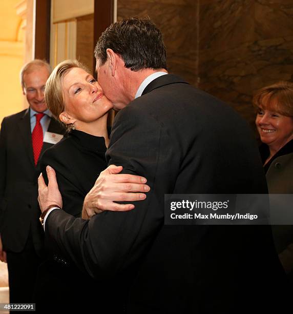 Sophie, Countess of Wessex kisses Sir Timothy Laurence as she arrives for a tour of Osborne House during a day of engagements on the Isle of Wight on...