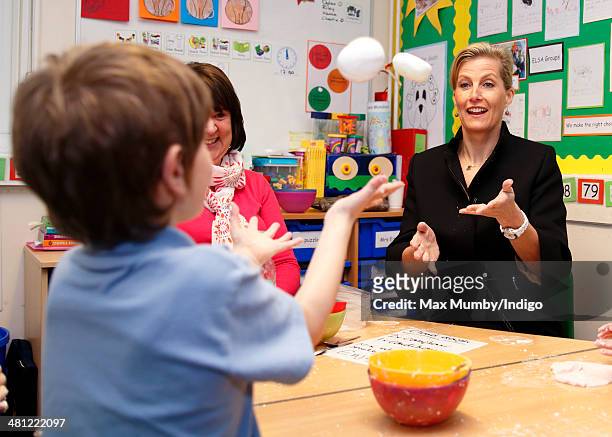 Sophie, Countess of Wessex plays throw and catch with some 'Cloud Dough' as she visits the Queensgate Foundation Primary School during a day of...