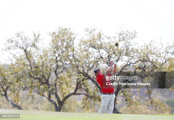 Pat Perez take his second shot on the 18th during Round Two of the Valero Texas Open at TPC San Antonio AT&T Oaks Courseon March 28, 2014 in San...