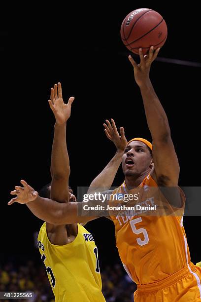 Jarnell Stokes of the Tennessee Volunteers shoots the ball against Jon Horford of the Michigan Wolverines during the regional semifinal of the 2014...