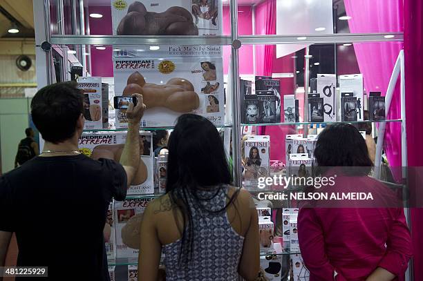 Visitors look at products in a stand during the Erotika Fair in Sao Paulo, Brazil, on March 28, 2014. The event, the biggest of its kind in Latin...