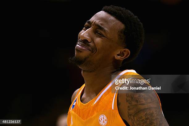 Jordan McRae of the Tennessee Volunteers reacts after missing the final shot of the game to be defeated by the Michigan Wolverines 73 to 71 during...