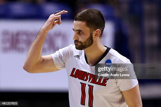Luke Hancock of the Louisville Cardinals reacts to a play against the Kentucky Wildcats during the regional semifinal of the 2014 NCAA Men's...