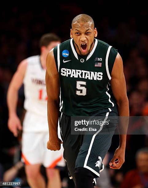 Adreian Payne of the Michigan State Spartans reacts after a basket against the Iowa State Cyclones during the regional semifinal of the 2014 NCAA...