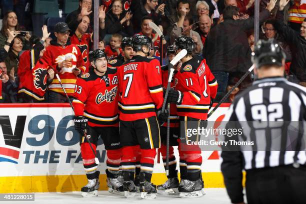 Michael Cammalleri, T.J. Brodie, Mikael Backlund and Mark Giordano of the Calgary Flames celebrate a goal against the New York Rangers at Scotiabank...