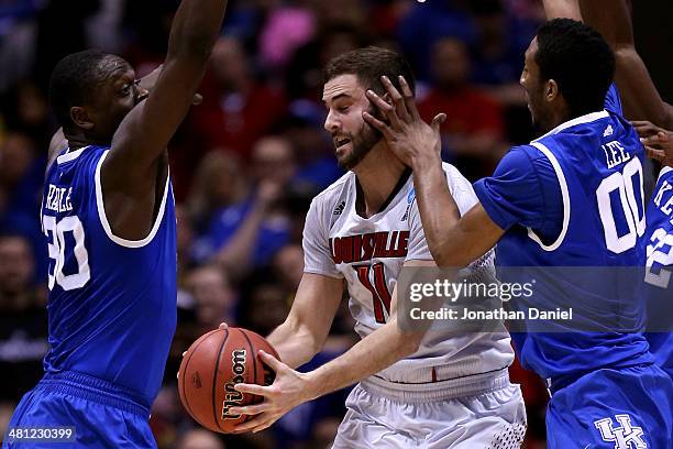 Marcus Lee of the Kentucky Wildcats hits Luke Hancock of the Louisville Cardinals in the face during the regional semifinal of the 2014 NCAA Men's...