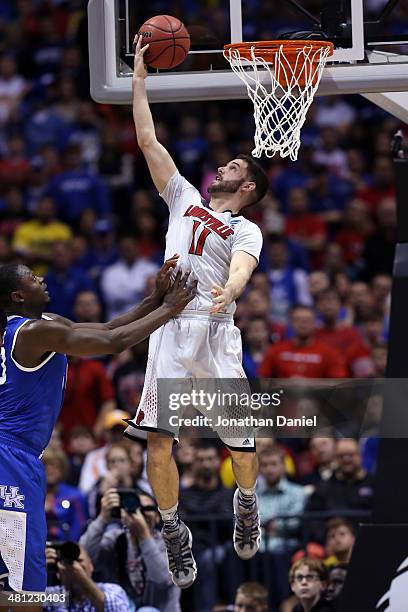 Luke Hancock of the Louisville Cardinals shoots the ball Julius Randle of the Kentucky Wildcats during the regional semifinal of the 2014 NCAA Men's...