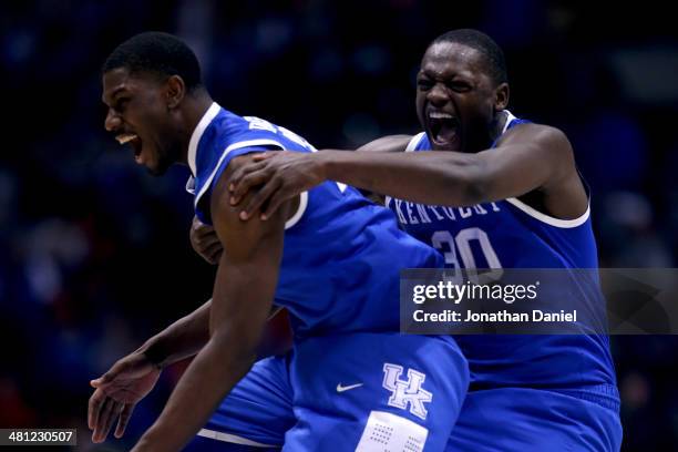 Alex Poythress and Julius Randle of the Kentucky Wildcats celebrate defeating the Louisville Cardinals 74 to 69 during the regional semifinal of the...