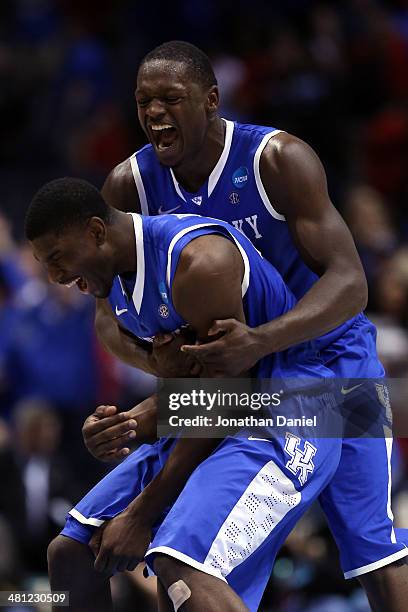 Alex Poythress and Julius Randle of the Kentucky Wildcats celebrate defeating the Louisville Cardinals 74 to 69 during the regional semifinal of the...