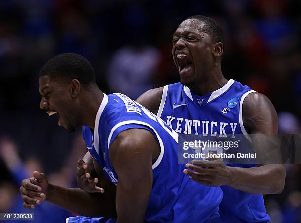 Alex Poythress and Julius Randle of the Kentucky Wildcats celebrate defeating the Louisville Cardinals 74 to 69 during the regional semifinal of the...