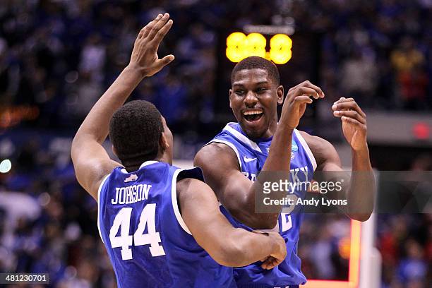 Dakari Johnson and Alex Poythress of the Kentucky Wildcats celebrate defeating the Louisville Cardinals 74 to 69 during the regional semifinal of the...