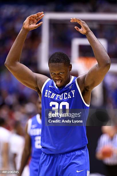Julius Randle of the Kentucky Wildcats celebrates defeating the Louisville Cardinals 74 to 69 during the regional semifinal of the 2014 NCAA Men's...