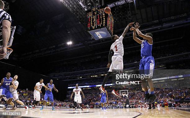Kentucky Wildcats guard Aaron Harrison nails this 3-pointer with less than a minute to go in the game to give Kentucky a 2-point lead over Louisville...