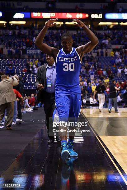 Julius Randle of the Kentucky Wildcats celebrates defeating the Louisville Cardinals 74 to 69 during the regional semifinal of the 2014 NCAA Men's...