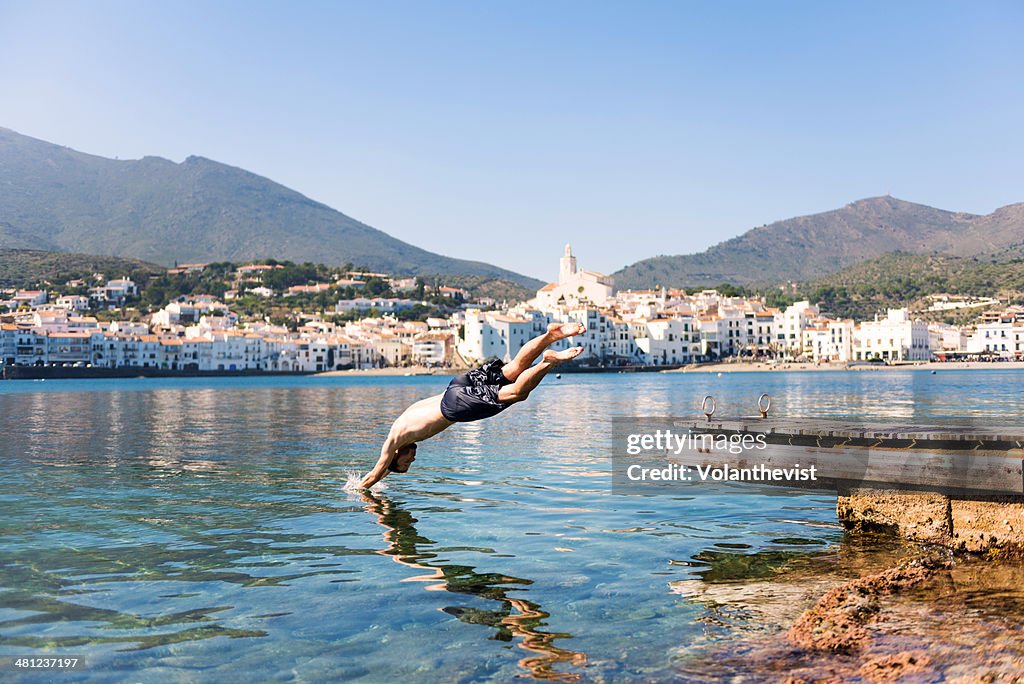 Man jumping into the water from a pier in Cadaqués
