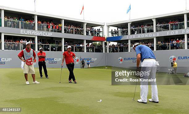 Gonzalo Fernandez-Castano of Team Europe holes his put on the 18th green to tie his match against Hideto Tanihara of Team Europe which left the...