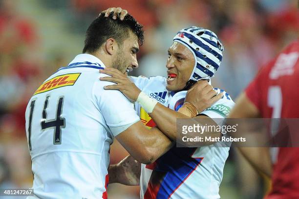 Damian De Allende of the Stomers scoring a try with Gio Aplon during the round seven Super Rugby match between the Reds and the Stormers at Suncorp...