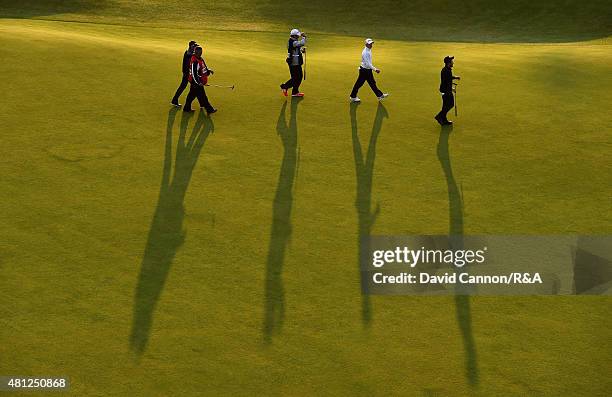 General view is seen as Tyrrell Hatton of England, Amateur Paul Kinnear of England and Scott Arnold of Australia walk up off the 18th hole with their...