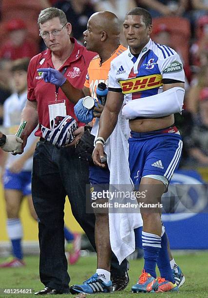 Gio Aplon of the Stormers is taken from the field injured during the round seven Super Rugby match between the Reds and the Stormers at Suncorp...