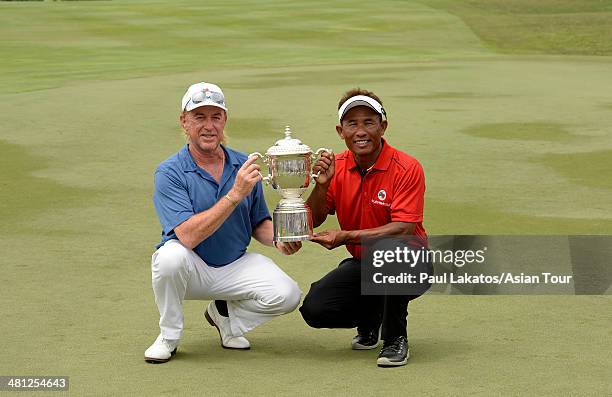 Team Europe captain Miguel Angel Jimenez of Spain and Team Asia captain, Thongchai Jaidee pose with the EurAsia Cup trophy during day three of the...