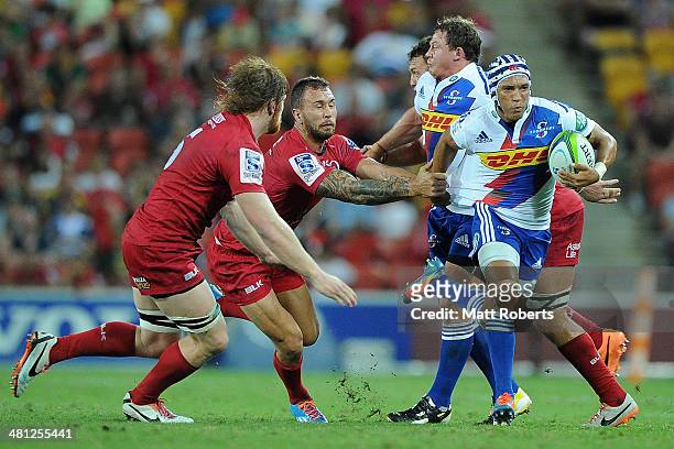 Gio Aplon of the Stormers takes on the defence during the round seven Super Rugby match between the Reds and the Stormers at Suncorp Stadium on March...