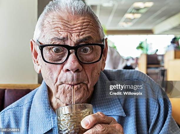 funny elderly man drinking with straw - suck stock pictures, royalty-free photos & images