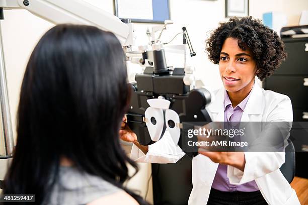 annual eye exam by the optometrist - opticien stockfoto's en -beelden