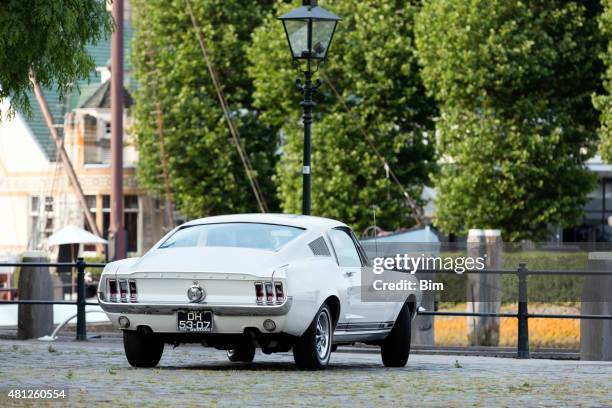 1967 ford mustang fastback in old yacht harbor in rotterdam - mustang boats stock pictures, royalty-free photos & images