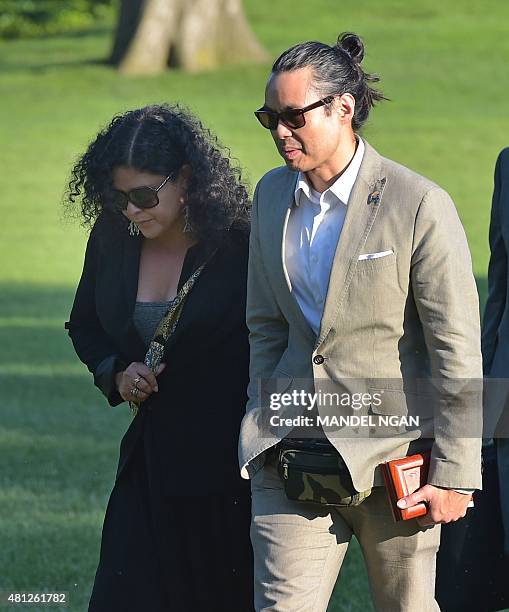 Maya Soetoro-Ng , the sister of US President Barack Obama, walks with her husband Konrad Ng across the South Lawn upon return to the White House on...