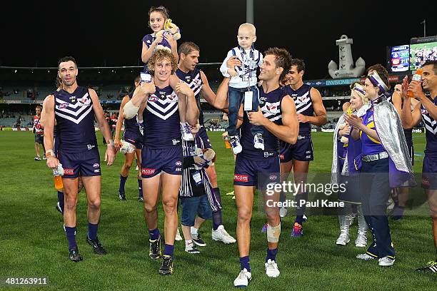 Chris Mayne and Matt De Boer of the Dockers chair off Starlight Foundation kids Tayten Dowson and Jackson Menegola after winning the round two AFL...