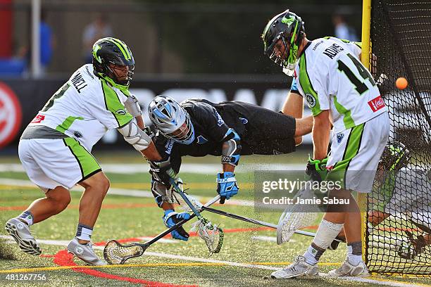 Goalie Drew Adams of the New York Lizards makes a save in the second quarter as Marcus Holman of the Ohio Machine attempts to score while Rob Pannell...