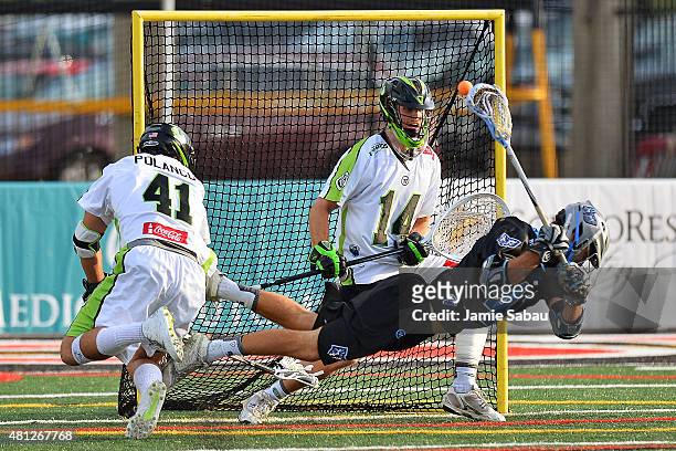 Kevin Cooper of the Ohio Machine scores from behind his back on goalie Drew Adams of the New York Lizards in the first quarter as Nicky Polanco of...
