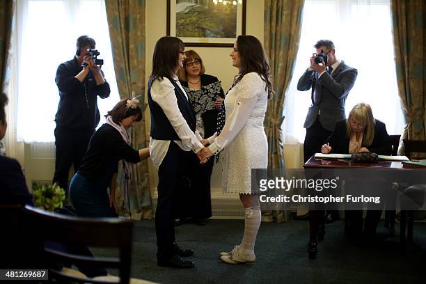 Helen Brearley and Teresa Millward hold hands during their wedding ceremony at Halifax Register Office, the day gay marriage becomes legal on March...