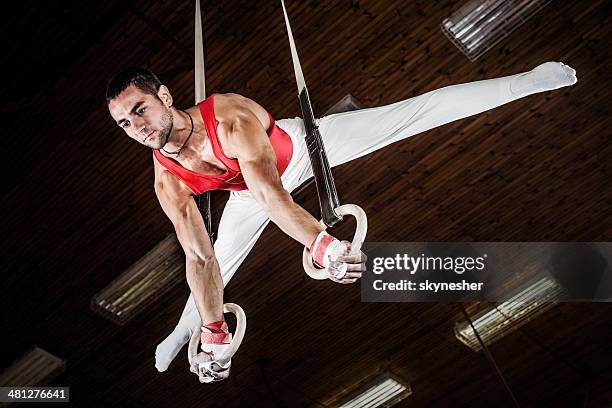 male sportsman on gymnastics rings. - gymnastic rings equipment bildbanksfoton och bilder