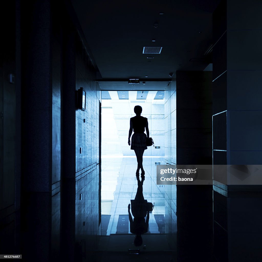 Woman walking into the light