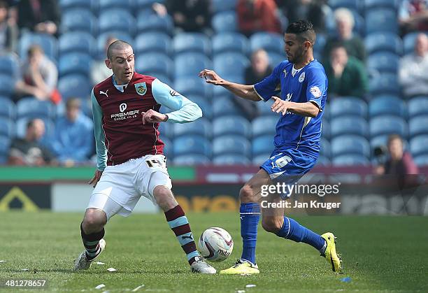 David Jones of Burnley battles with Riyad Mahrez of Leicester City during the Sky Bet Championship match between Burnley and Leicester City at Turf...