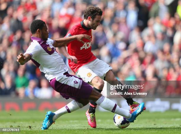 Leandro Bacuna of Aston Villa fouls Juan Mata of Manchester United to concede a penalty kick during the Barclays Premier League match between...