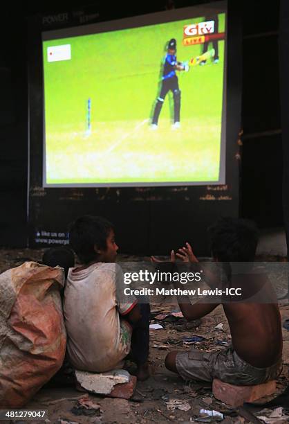 Two young boys watch the New Zealand versus Netherlands match during the ICC World Twenty20 Bangladesh 2014 in the Old Town on March 29, 2014 in...