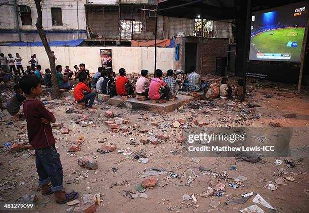 Young boy watches the New Zealand versus Netherlands match during the ICC World Twenty20 Bangladesh 2014 in the Old Town on March 29, 2014 in Dhaka,...