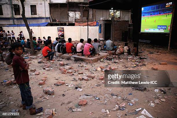 Young boy watches the New Zealand versus Netherlands match during the ICC World Twenty20 Bangladesh 2014 in the Old Town on March 29, 2014 in Dhaka,...