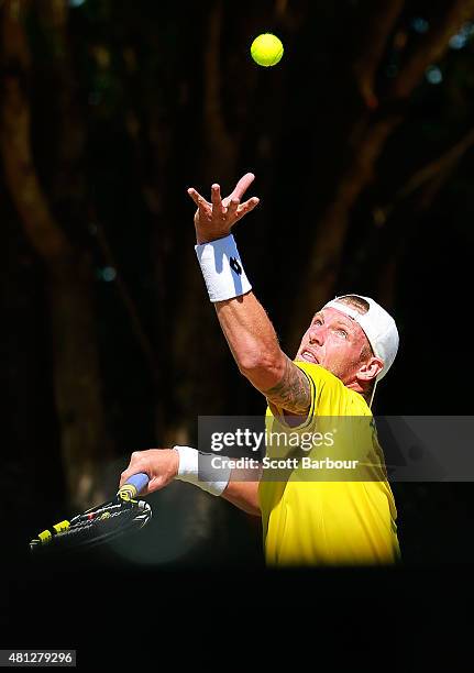 Sam Groth of Australia serves during the reverse singles match between Sam Groth of Australia and Mikhail Kukushkin of Kazakhstan during day three of...