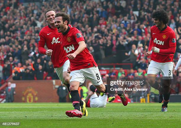 Juan Mata of Manchester United celebrates scoring his team's third goal during the Barclays Premier League match between Manchester United and Aston...