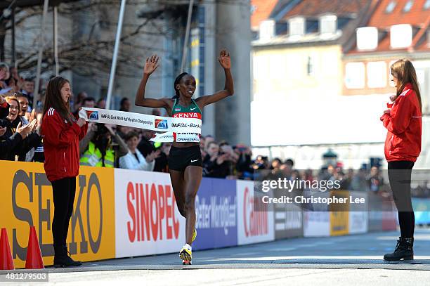 Gladys Cherono of Kenya celebrates as she crosses the finish line in first place during the IAAF/Al-Bank World Half Marathon Championships on March...