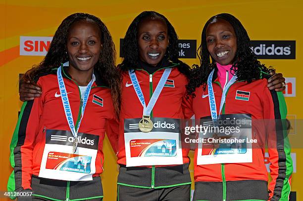 Silver medalist Mary Wacera Ngugi, Gold medalist Gladys Cherono and bronze medalist Selly Chepyego Kaptich of Kenya celebrate on the podium after the...