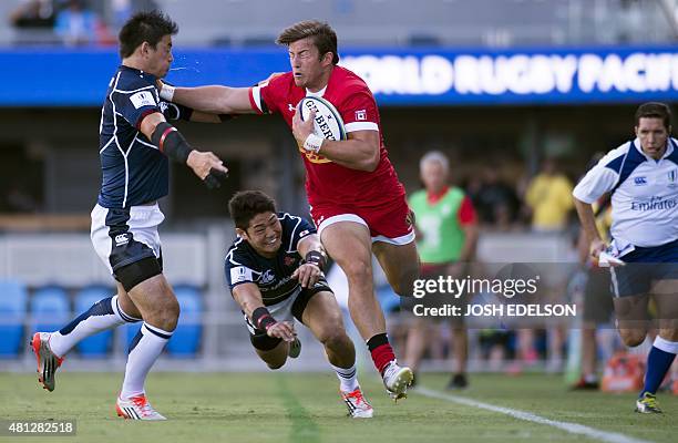 Yoshikazu Fujita of Japan takes a hit from Daniel Tailliferrer Hauman van der Merwe of Canada during a World Rugby Pacific Nations Cup match where...