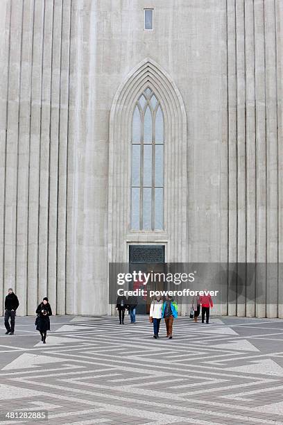 people leaving hallgrímskirkja church in reykjavík, iceland - hallgrimskirkja stock pictures, royalty-free photos & images