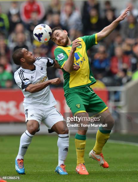 Wayne Routledge of Swansea City challenges Robert Snodgrass of Norwich City during the Barclays Premier League match between Swansea City and Norwich...