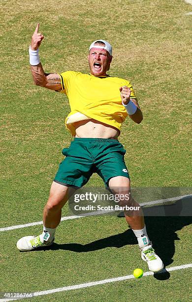 Sam Groth of Australia celebrates match point after winning the reverse singles match between Sam Groth of Australia and Mikhail Kukushkin of...