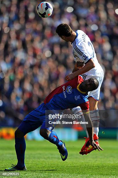 Nemanja Matic of Chelsea risea above Cameron Jerome of Crystal Palace to head the ball clear during the Barclays Premier League match between Crystal...
